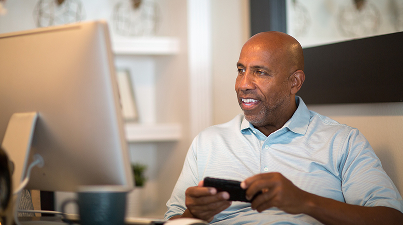 Man Phone Computer Desk Adobestock 249211523